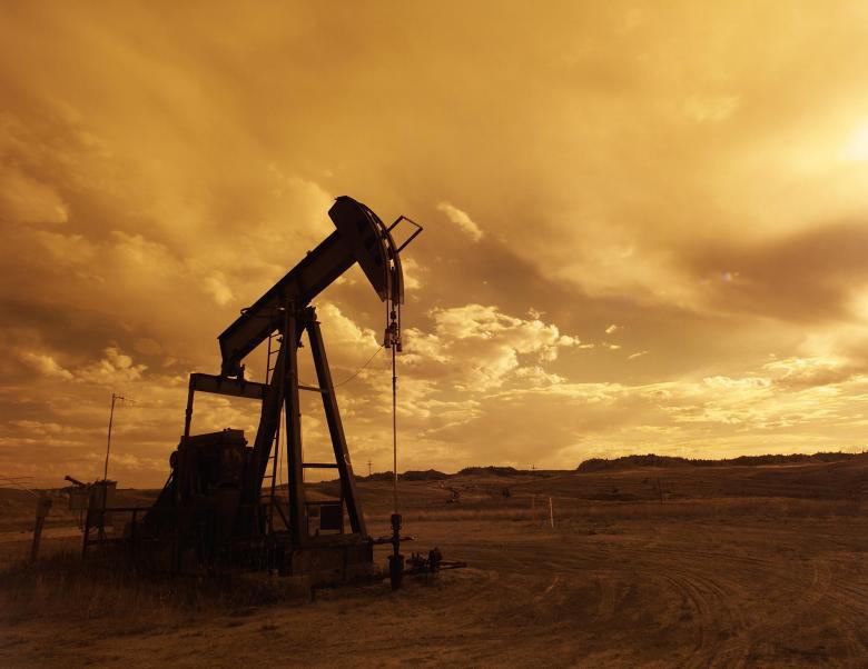 Oil pump jack on open prairie landscape